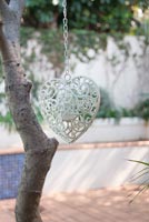Heart shaped decoration hanging from tree