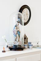 Religious statue in bell jar
