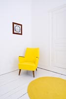 Salvaged chair painted in acrylic paint with circular felt rug