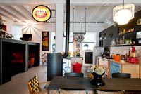 Open plan kitchen diner with vintage, salvaged and customized furniture