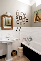 Classic bathroom with vintage pictures and frames