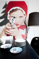Contemporary dining room detail with 'Little Red Riding Hood Aiming Revolver' photo by Sandra Seckinger