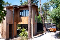 Contemporary wooden house surrounded by trees