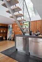 Contemporary open plan kitchen under stairs