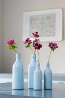 Anemone flowers in blue bottles