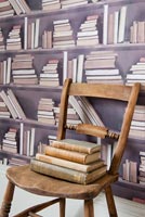 Wooden chair and patterned wallpaper