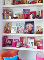 Colourful display on white shelves
