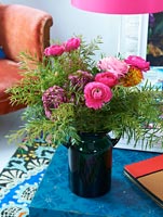 Colourful flower arrangement on blue coffee table