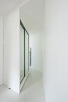 Contemporary curved corridor with mirrored cupboards