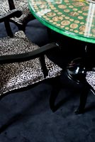 Cammei table by Fornassetti with animal print chairs