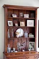 Photos and ornaments on wooden shelves