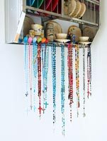 Beads hanging from metal plate rack