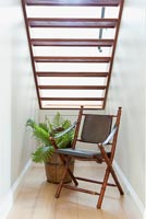 Folding chair under stairs