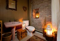 Country bathroom lit with candles
