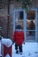 Boy standing in snow 
