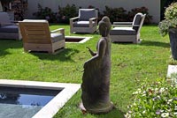 Modern garden with Asian sculpture and pond