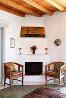 Traditional fireplace and wooden chairs