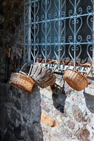 Baskets hanging from window grille