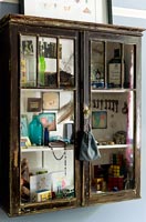 Vintage ornaments and accessories displayed in wooden cabinet