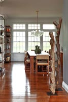 Wooden sculptures in contemporary open plan dining room
