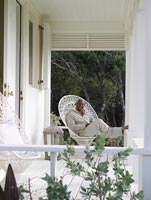 Antonius Roberts sitting on the veranda of his house 
