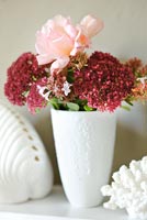 Roses and Sedum flowers in modern vase