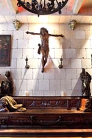 Statue of christ above carved wooden seating