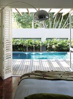 Modern bedroom overlooking swimming pool