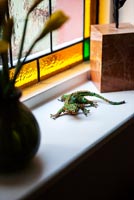 Lizard sculpture by Susan Horth on windowsill