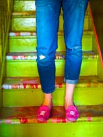 Woman standing on painted stairs