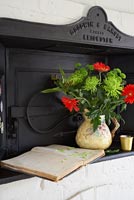 Colourful arrangement of Chrysanthemums and Gerbera flowers on bread oven