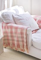 White chair with checked blanket