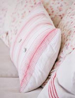 Homemade cushions and vintage quilt 