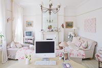 White sitting room with vintage dressing table used as desk
