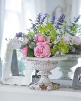 Vintage urn with arrangement of Roses, Catmint and Ladys Mantle flowers