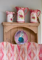 Dresser with pink jugs, biscuit tin and 1930s fabric covered screen