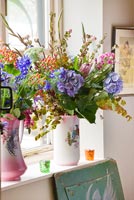 Colourful flowers in patterned jugs