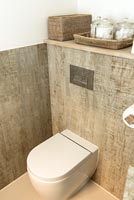 Modern toilet and wood effect tiles