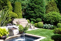 Formal country garden with small pond and patio