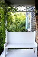 White bench on porch