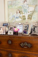 Family photos displayed on chest of drawers