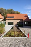 Modern house and gravel garden with pond