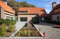 Modern house and gravel garden with pond