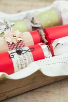 Step by Step guide for making Christmas Crackers - finished crackers in wooden tray