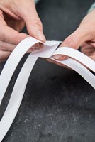 Using paper strips to create star shaped decorations -  folding strips over one another