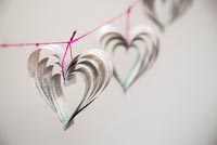 Creating a heart shaped decoration using newspaper and coloured thread - finished hearts