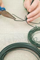 Using cotton wool and garden wire to create a Christmas tree - Bending bottom sections of wire to create base of tree