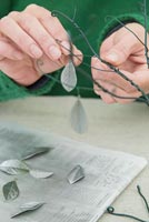 Using cotton wool and garden wire to create a Christmas tree - Hanging Cotoneaster leaves on branches