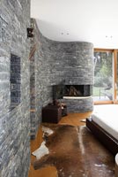 Modern bedroom with stone wall