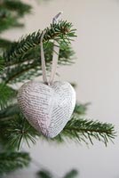 Heart shaped decoration made from newspaper, polystyrene and ribbon 